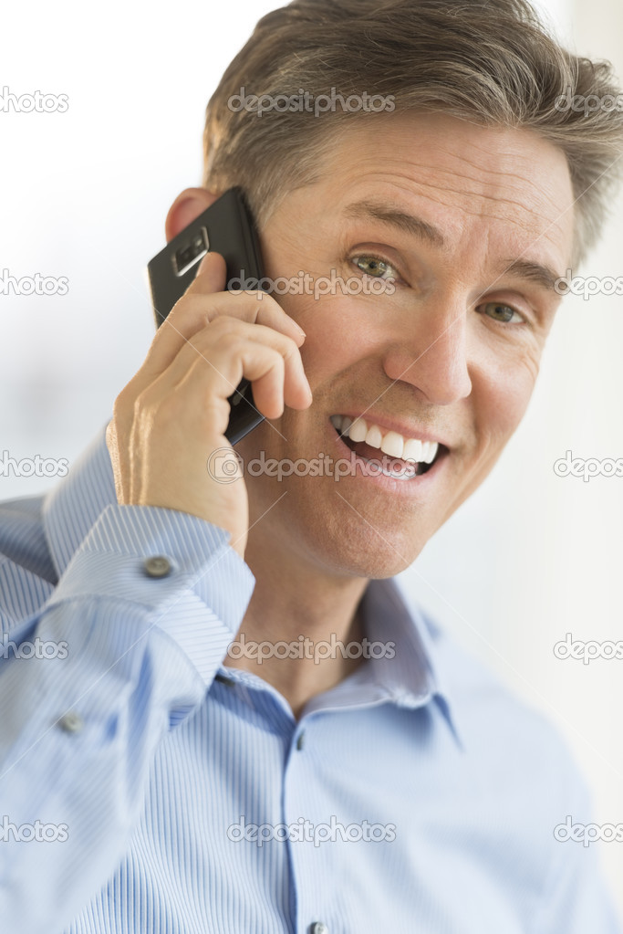 Portrait Of Cheerful Businessman Using Smart Phone