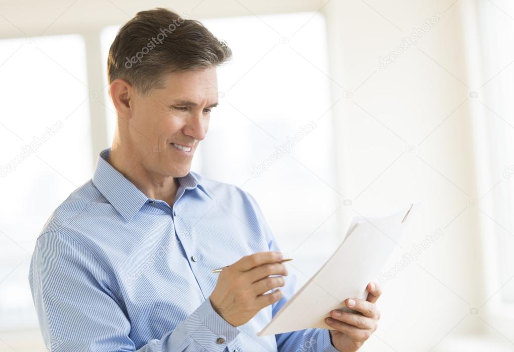 Happy Businessman Reading Document