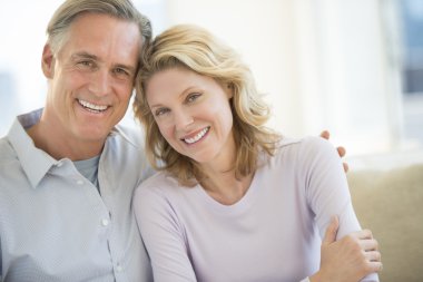 Couple Smiling Together At Home clipart