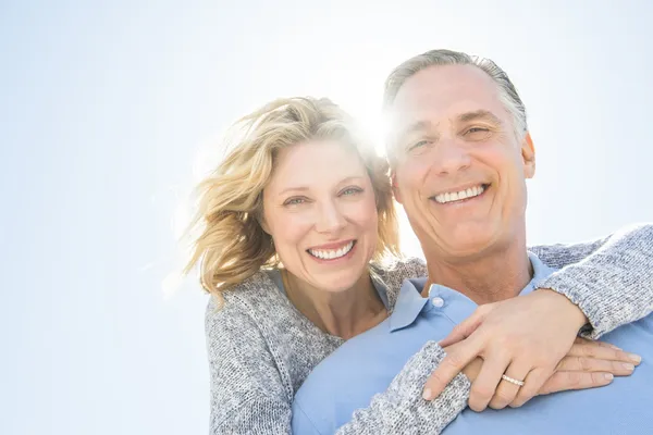 Cheerful Woman Embracing Man From Behind Against Sky — Stock Photo, Image