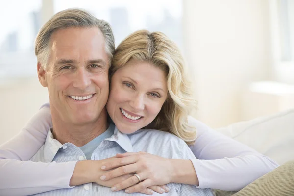 Loving Woman Embracing Man From Behind At Home — Stock Photo, Image