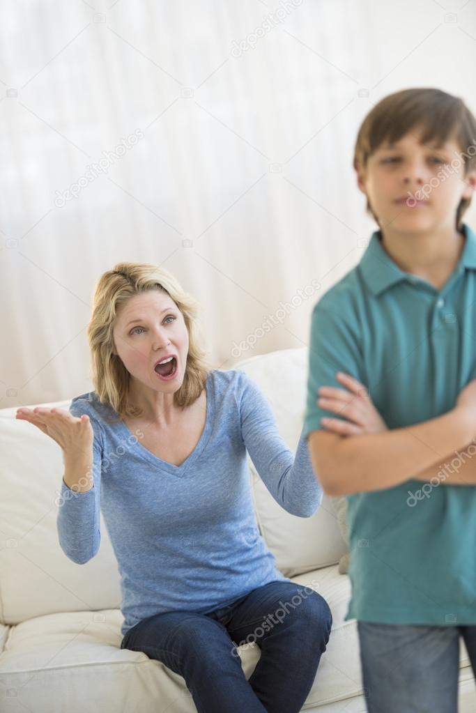 Mother Shouting While Son Ignoring Her At Home