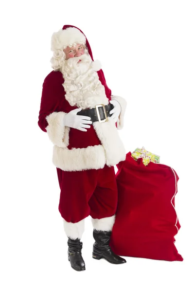 Santa claus stojící s taškou plnou dárků — Stock fotografie