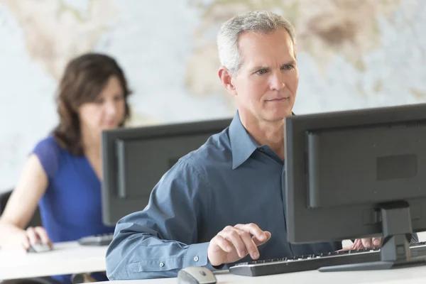 Homme d'affaires mature utilisant l'ordinateur dans le bureau — Photo