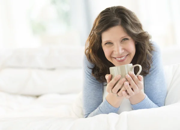 Beautiful Woman Holding Coffee Mug In Bed — Stock Photo, Image