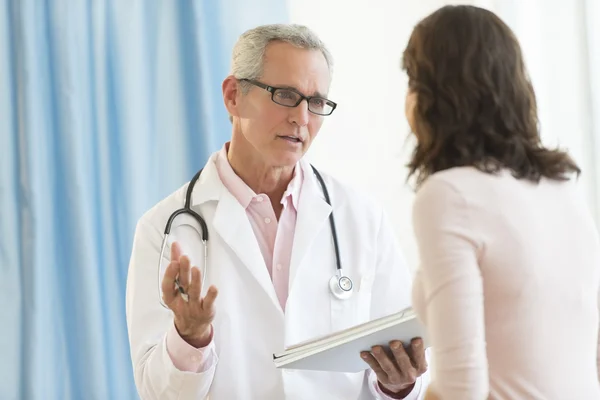 Manliga läkare diskutera med patienten i klinik — Stockfoto