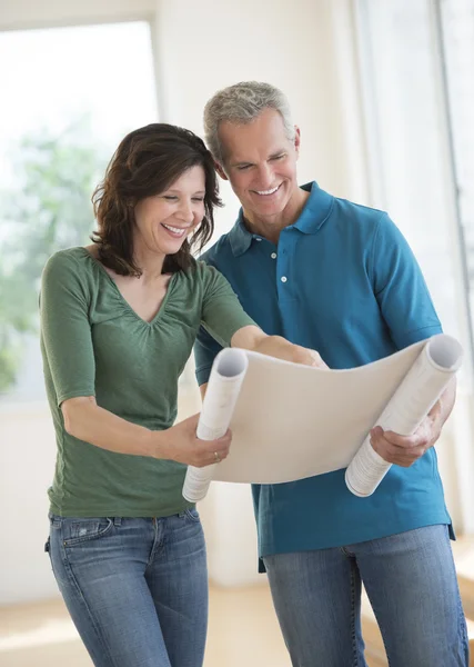 Woman Showing Blueprint To Husband In New House — Stock Photo, Image