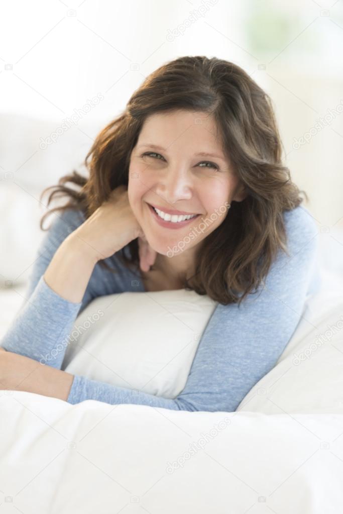 Attractive Woman Lying In Bed At Home