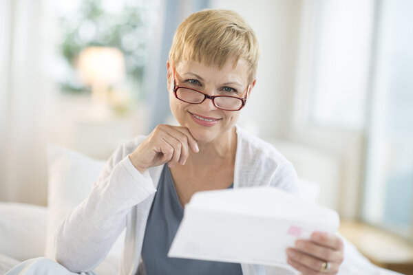 Smiling Mature Woman Holding Envelope