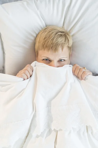 Woman Hiding Her Face Behind Duvet — Stock Photo, Image