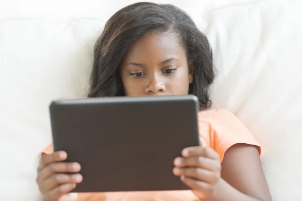 Dívka pomocí digitálních tabletu na pohovce — Stock fotografie