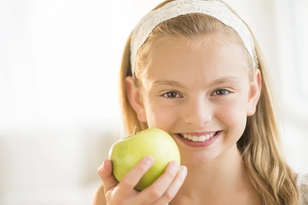 Girl Holding Green Apple At Home Stock Picture