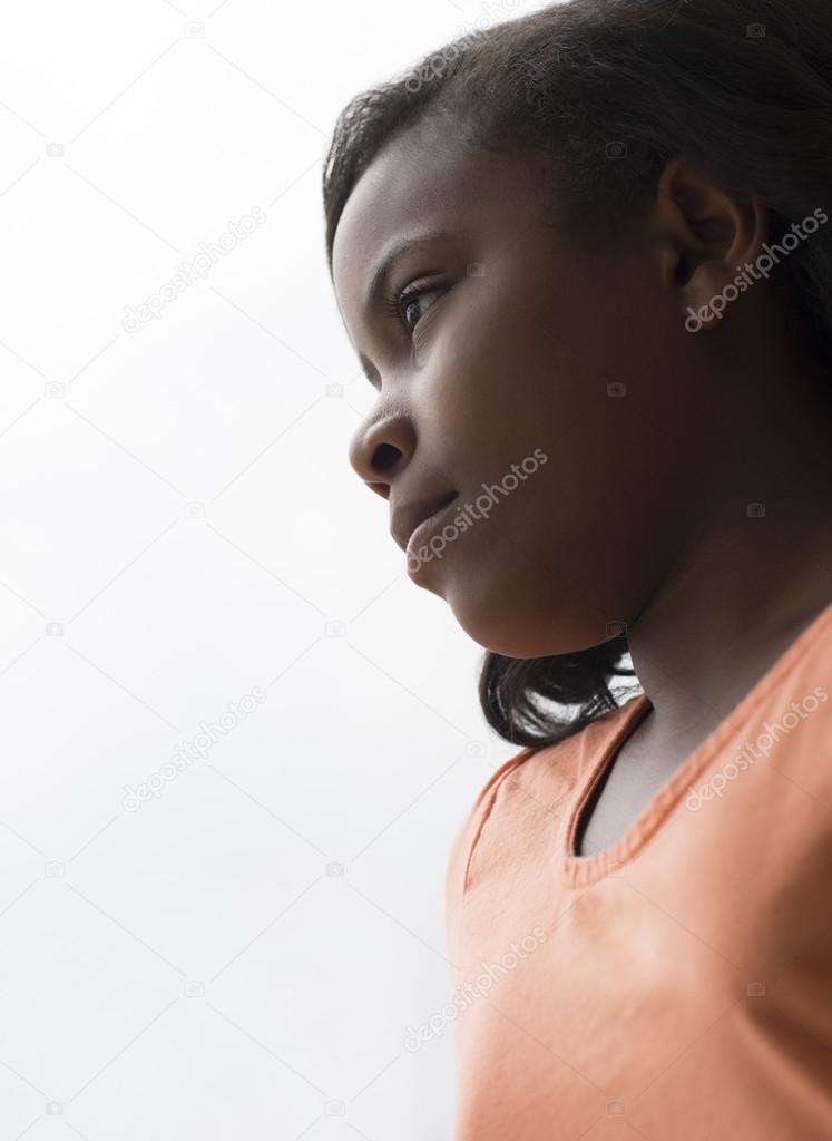 Girl Looking Through Window At Home