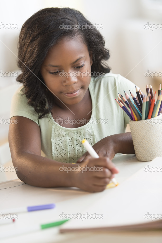Girl Coloring At Table