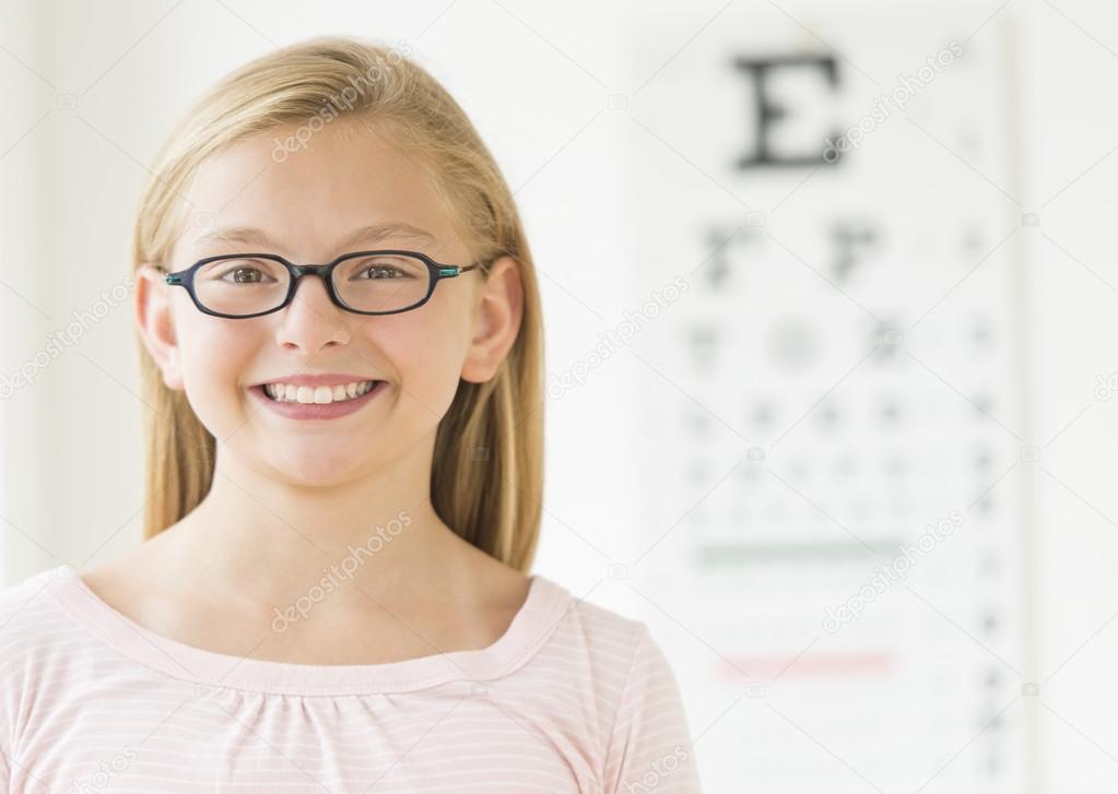 Girl Wearing Glasses Against Eye Chart