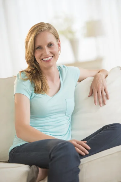 Happy Young Woman Relaxing On Sofa — Stock Photo, Image