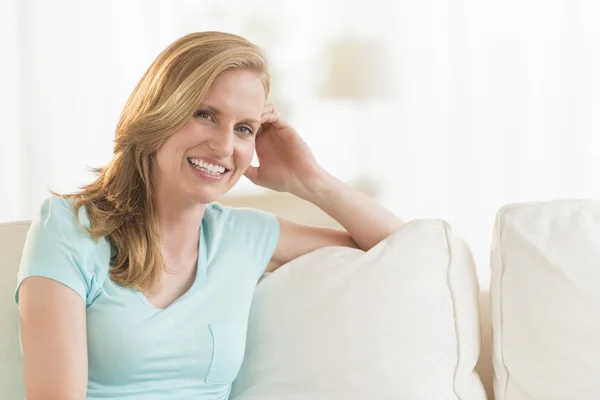 Happy Young Woman Relaxing On Sofa — Stock Photo, Image