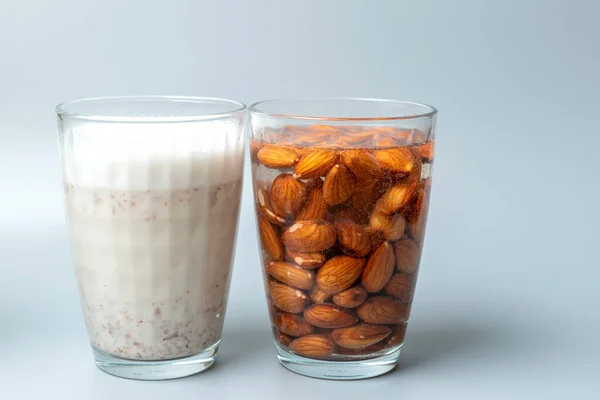 View from side of glasses with almonds nuts and almonds nuts milk.