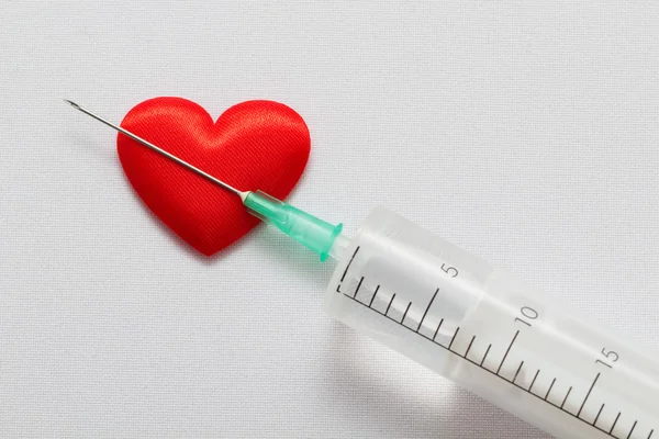Heart and syringe with a needle