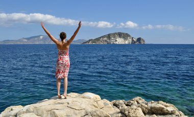 Eller yukarı deniz kenarı olan kadın