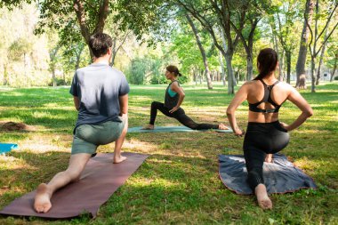 yoga teacher teaching in the park