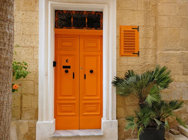 Traditional vintage painted wooden door in Malta. Popular travel destination. Entrance to house. Exterior of typical houses on the Mediterranean island of Malta - April, 2022.