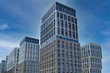 Exterior of a modern building house object with texture walls and windows. Luxury modern tall block of flats without balconies. Living apartments or office building. Real estate concept.