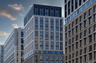 Exterior of a modern building house object with texture walls and windows. Luxury modern tall block of flats without balconies. Living apartments or office building. Real estate concept.