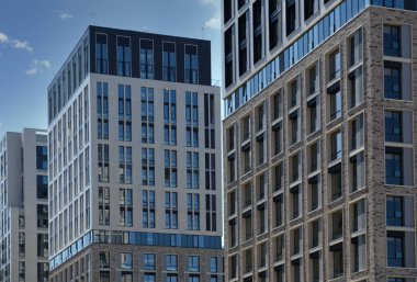 Exterior of a modern building house object with texture walls and windows. Luxury modern tall block of flats without balconies. Living apartments or office building. Real estate concept.