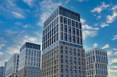 Exterior of a modern building house object with texture walls and windows. Luxury modern tall block of flats without balconies. Living apartments or office building. Real estate concept.