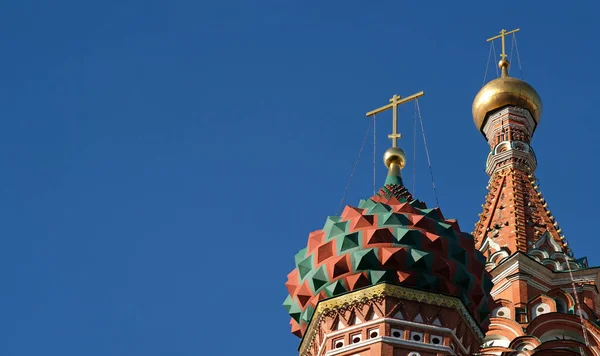 Ancient and medieval golden Domes with golden crosses on the Orthodox Church against the blue sky with copy space. Byzantine style. Banner, postcard or poster of a religious theme.