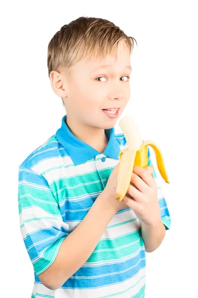 Mladý chlapec jíst banán — Stock fotografie
