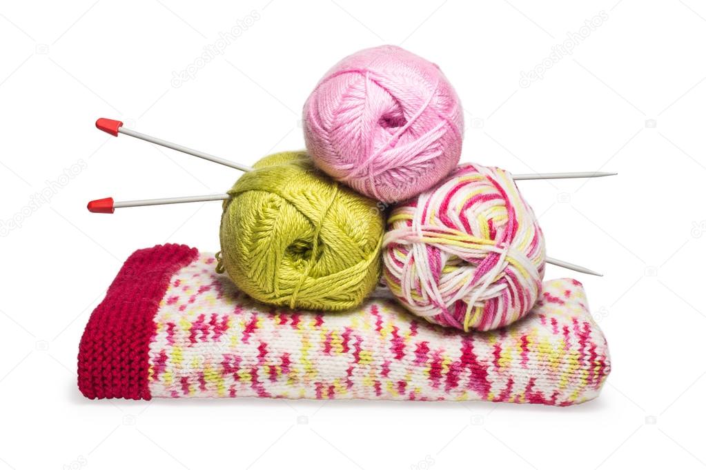 balls of wool on hand knitted children dress