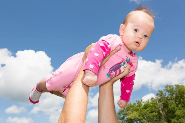 Little Baby Girl Against Cloudy Sky Stock Picture