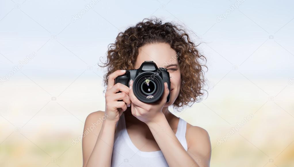 beautiful girl taking a photograph