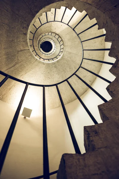 Spiral staircases, section and golden spiral. Stairwell. Ancient architecture. View from bottom to top.