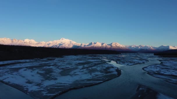 日の出に冬のデナリ山とチュリトナ川。アラスカ、アメリカ。空中展望 — ストック動画