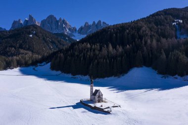 Church of St John, Forest and Dolomites on Sunny Winter Day. South Tyrol, Italy. Aerial View.