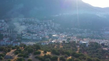White Houses of Kas Town and Mountains on Sunny Day. Antalya, Turkey. Aerial View. Drone Flies Sideways