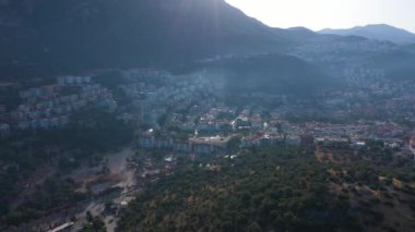 Kas Town and Mountains on Sunny Day. Antalya, Turkey. Aerial View. Drone Flies Sideways