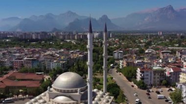 White Mosque, Cityscape and Mountains. Antalya, Turkey. Aerial View. Drone Flies Backwards and Upwards
