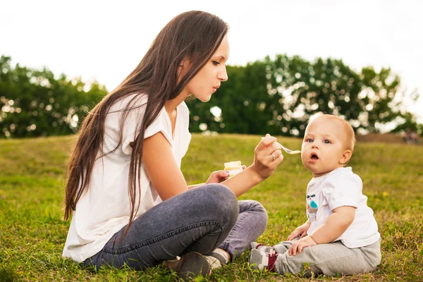 Baby eating outdoors — Stock Photo, Image