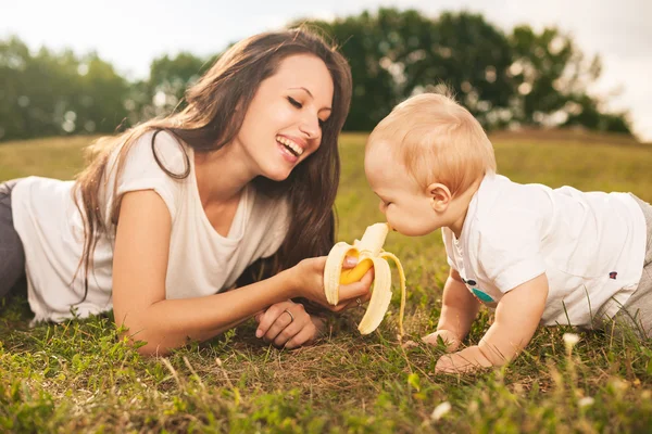 Baby eating outdoors — Stock Photo, Image