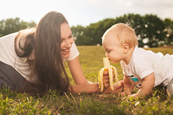 Baby eating outdoors — Stock Photo, Image