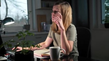 Ev ofisinde uzaktan çalışan yorgun bir kadın, serbest çalışan aşırı çalışan.