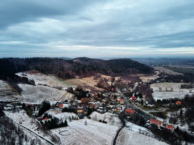 Winter landscape with mvillage near mountains