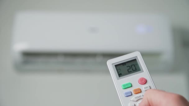 Hand adjusting temperature on air conditioner — 图库视频影像