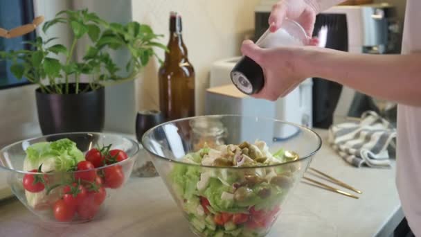 Frau bereitet grünen Gemüsesalat in Schüssel in Küche zu — Stockvideo