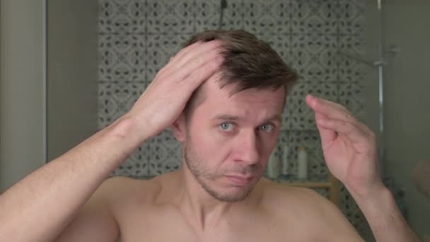 Man Inspects Receding Thinning Hair Bathroom — Stock Video