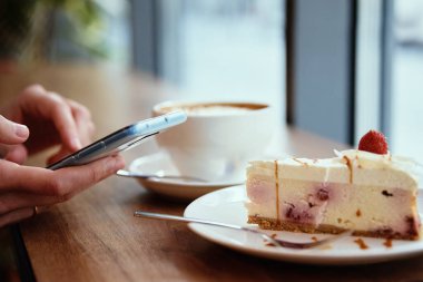 Kadınlar kafede kahvaltı eder, kafelerde akıllı telefon kullanır.